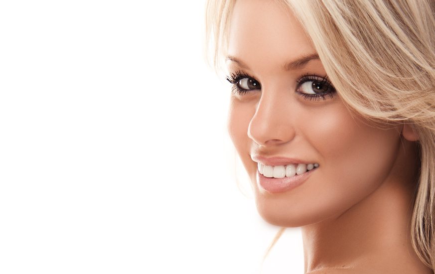 Image with beautiful smiling blonde girl on white background closeup